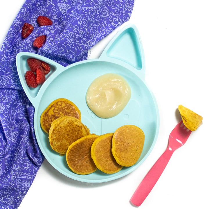 Plate of pumpkin pancakes for baby and toddler with a pear dipping sauce.