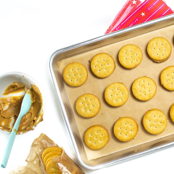 Sheet pan of ritz crackers and peanut butter.