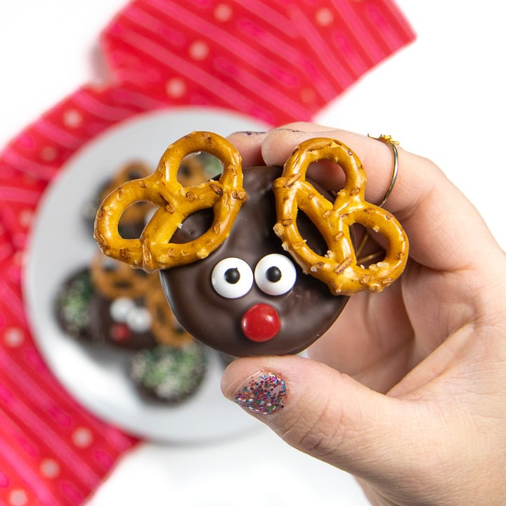 Hand holding up a chocolate reindeer cookie.