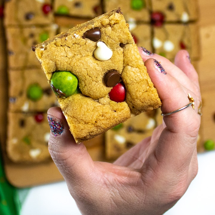 Hand holding up a Christmas cookie bar.