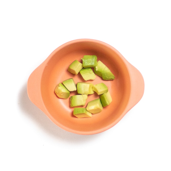 Small snack bowl full of chunks of avocado.