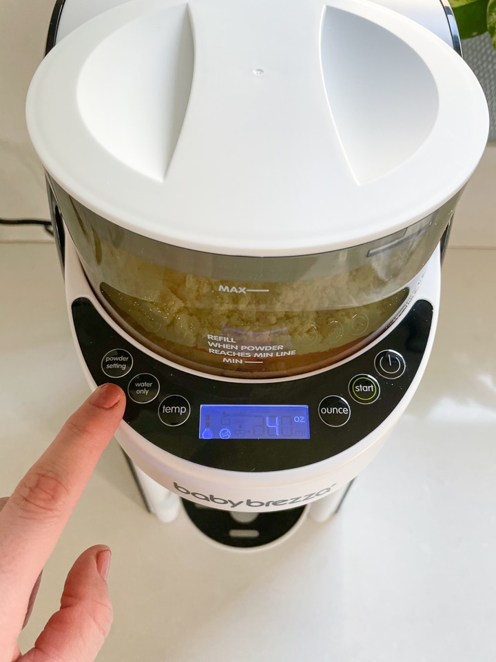 Finger pointing to the powder setting on the baby Brezza.