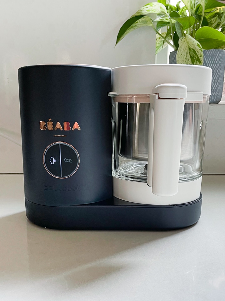 Up close shot of a Beaba babycook with the steam light on.