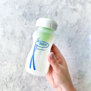 A hand holding a empty bottle.