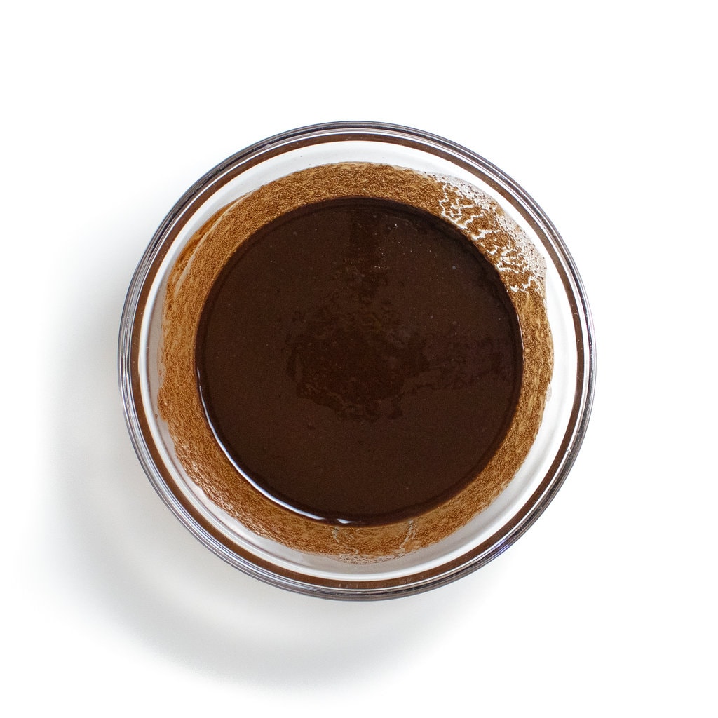 Glass bowl with the butter and chocolate heated together.