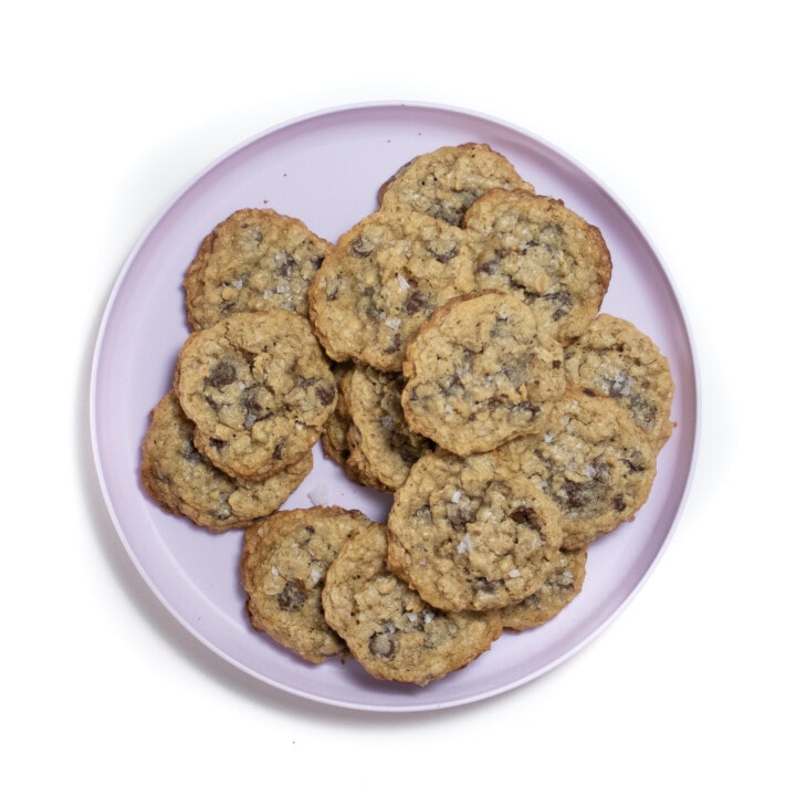 Purple plate full of chocolate chip oatmeal lactation cookies.