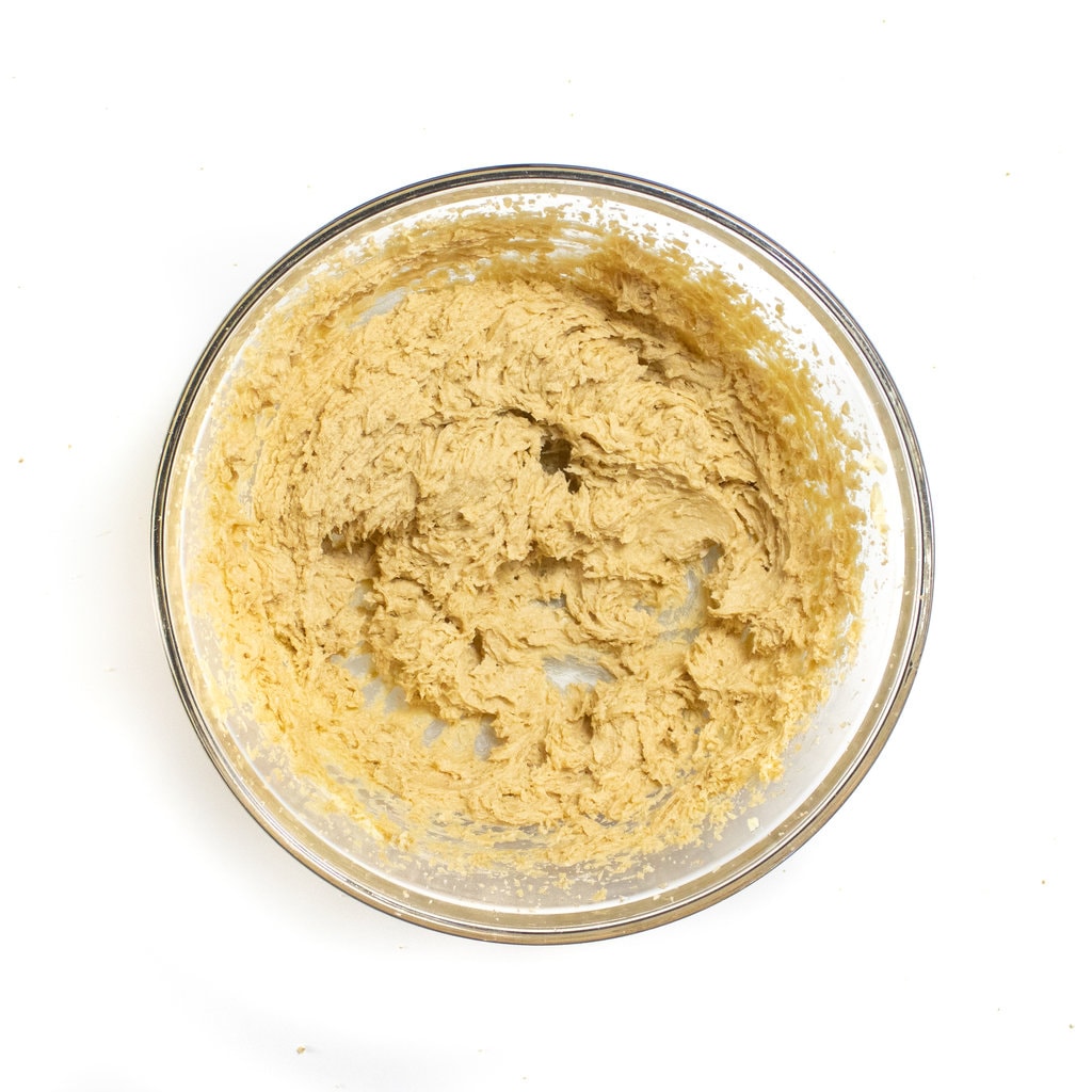 A mixing bowl with whipped butter and sugar.