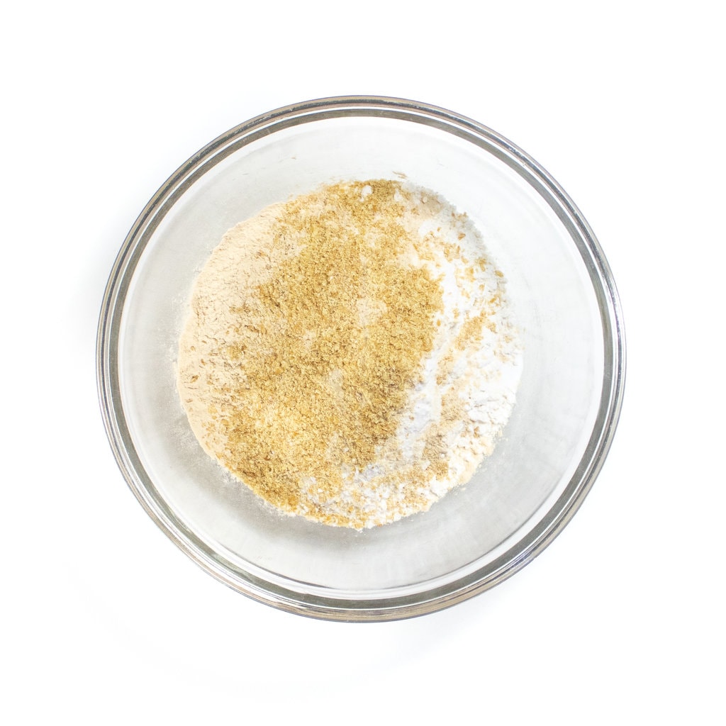 The mixing bowl with flour, baking soda, salt, ground flaxseeds and brewers yeast for cookies.