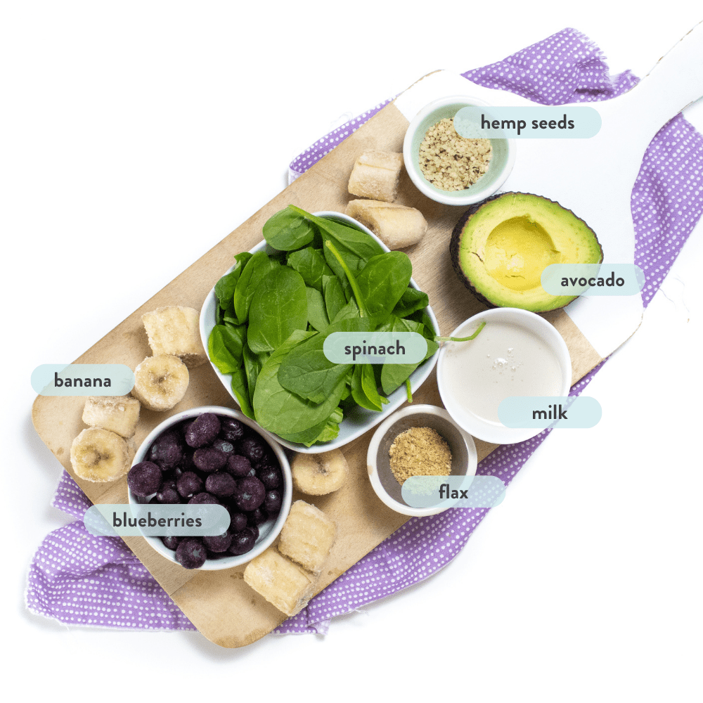 spread of smooth ingredients on a cutting board with a purple napkin on a white background.