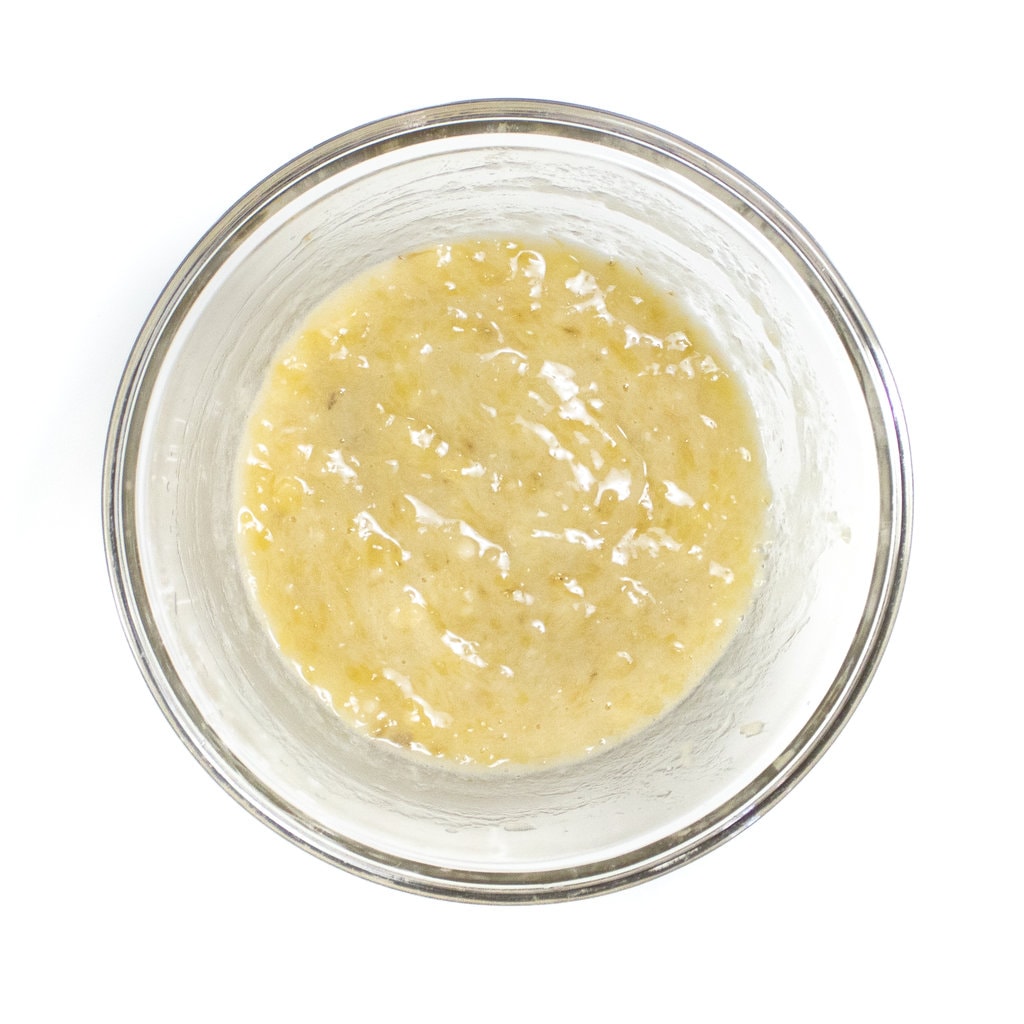 Clear bowl with mashed bananas.