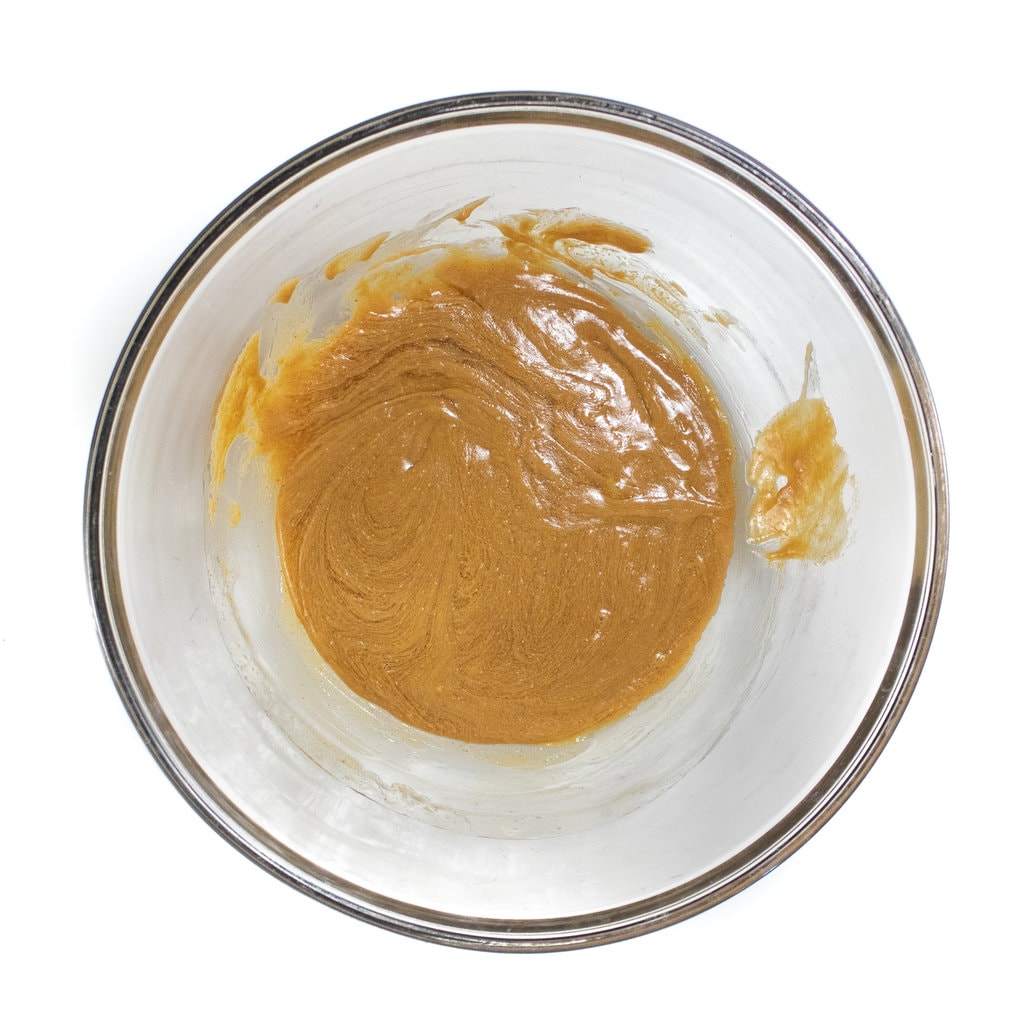 A clear glass bowl filled with mixed ingredients.