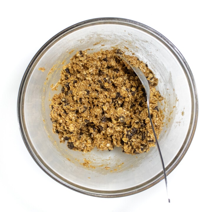 A clear glass bowl filled with mixed ingredients for lactation balls.
