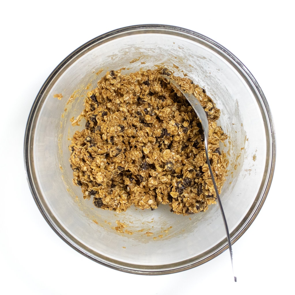 A clear glass bowl filled with mixed ingredients for lactation balls.