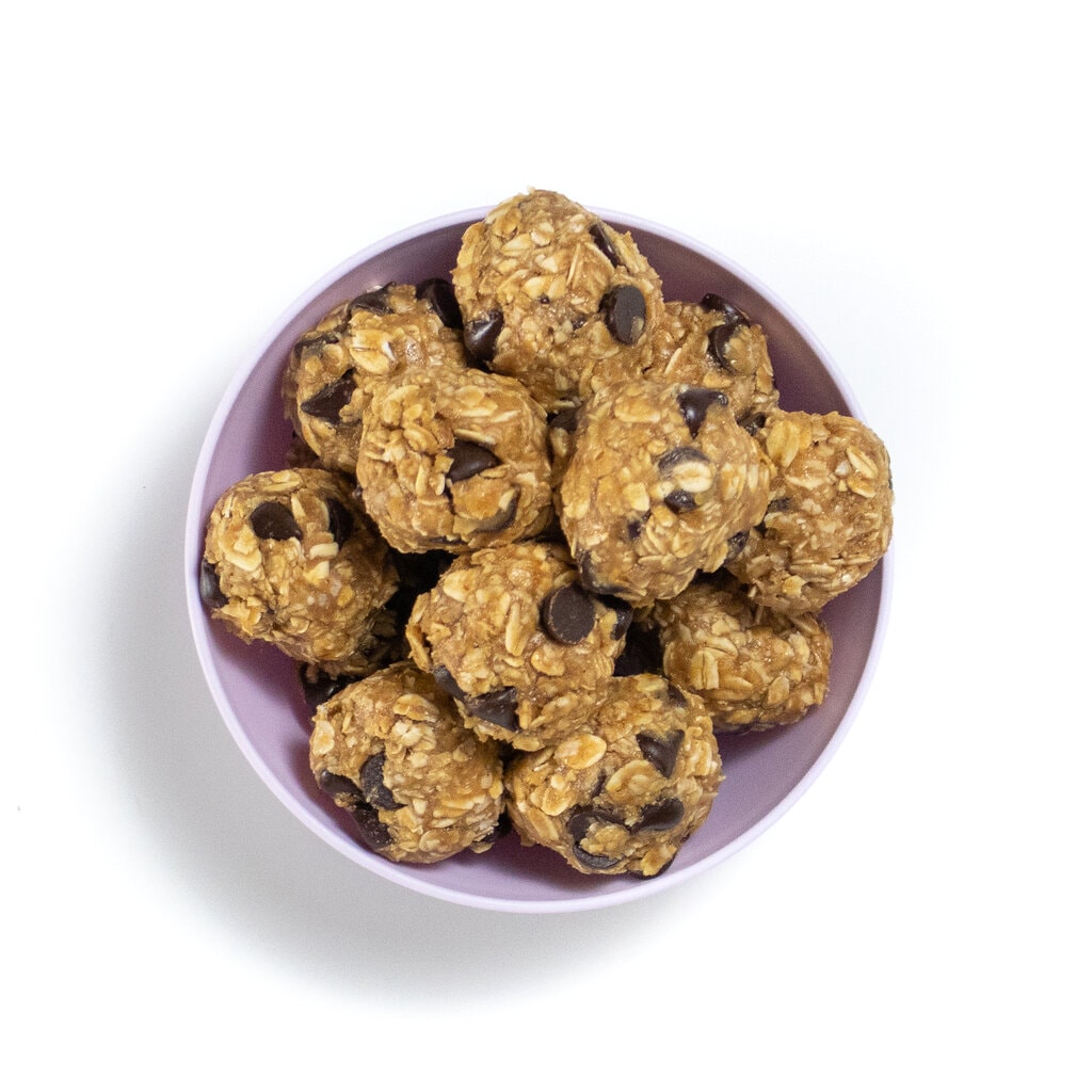 A purple bowl full of oats and peanut butter lactation bites.