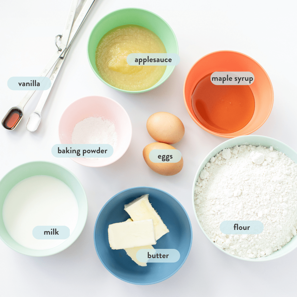 Spread of ingredients in colorful bowls against a white background.