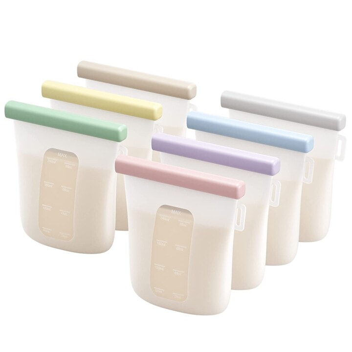 White and clear silicone breast milk storage bags with colorful clasps to close the bags.