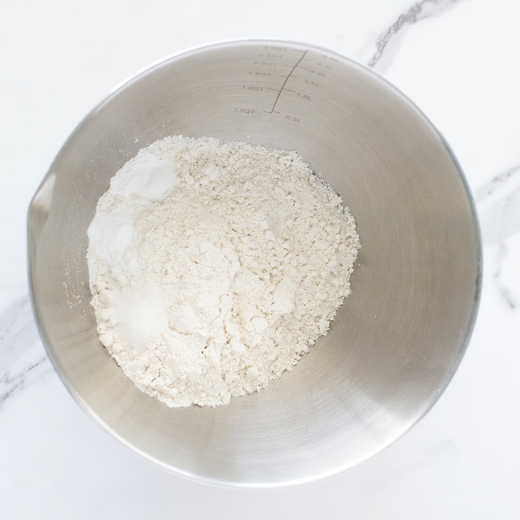 A silver bowl with dry ingredients for muffins.