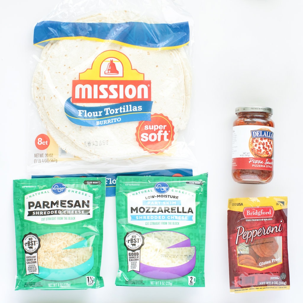 The ingredients for pizza quesadillas spread on the counter.