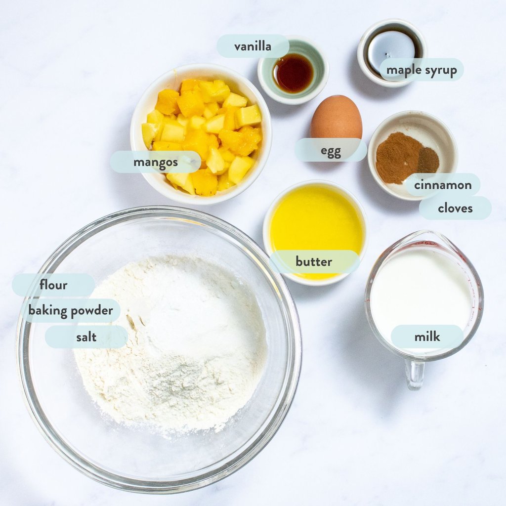Ingredients for mango pancake scattered on a marble counter top.