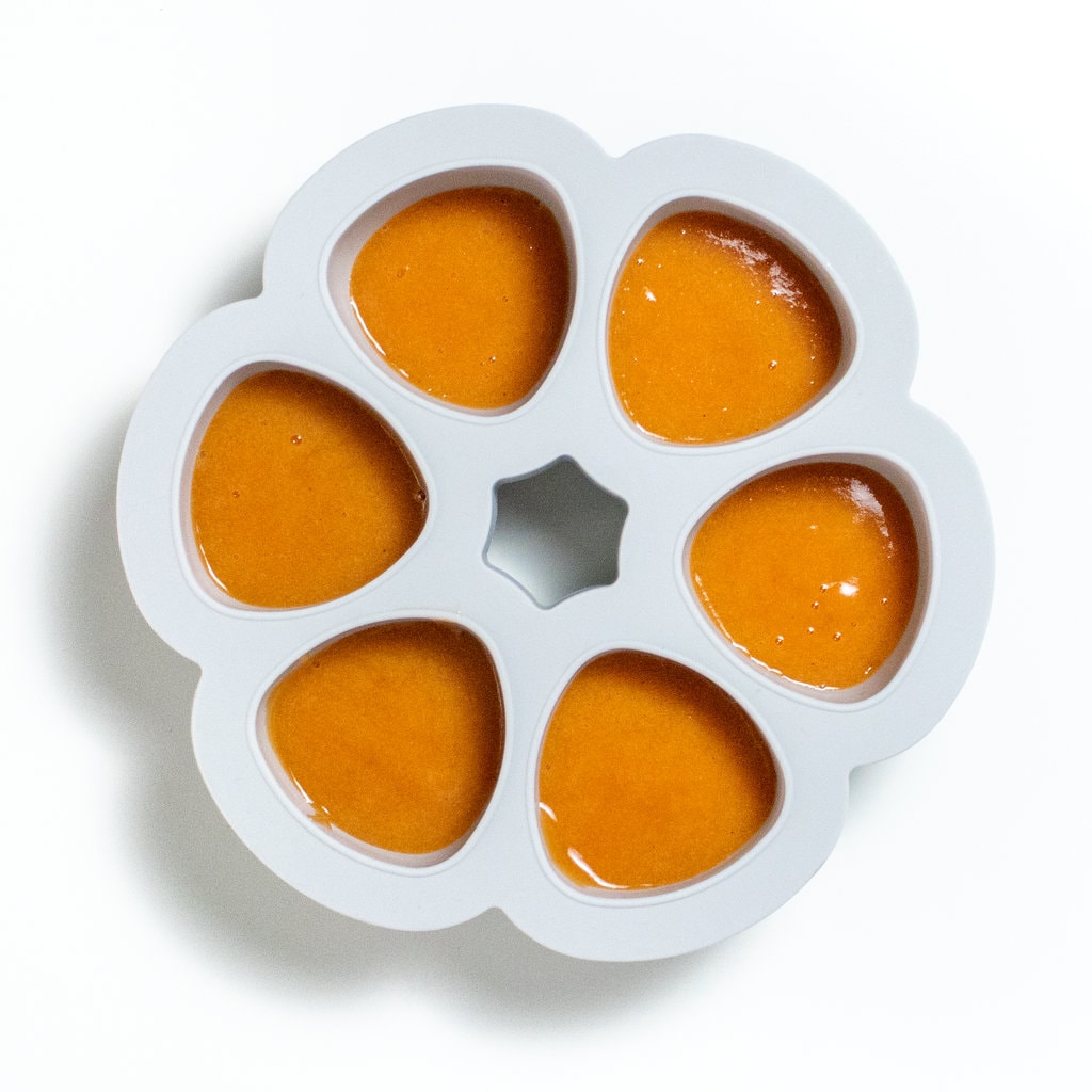 A baby food freezer tray full of nectarine purée.
