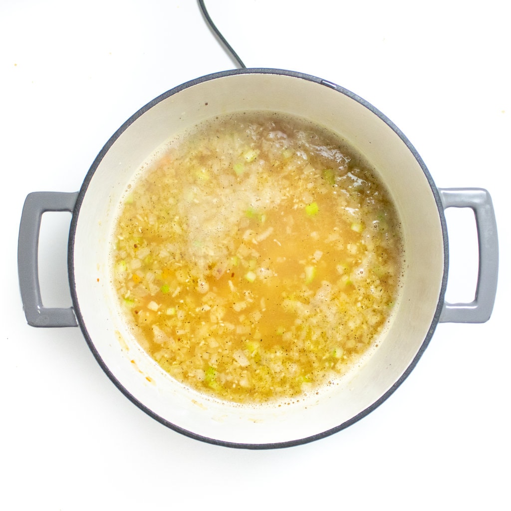 Large gray sofa with the base ingredients for chicken and stars soup.