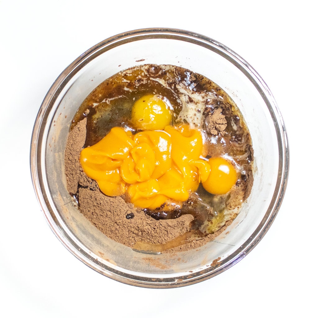 Claire mixi bowl on white countertop with wet and dry ingredients for sweet potato brownies.
