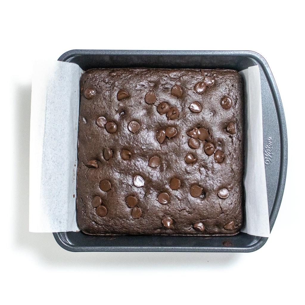 Baked pan of sweet potato brownies with chocolate chips on top.