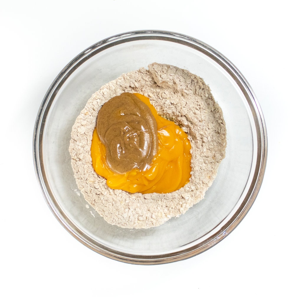 Clear bowl with both wet and dry ingredients in it.