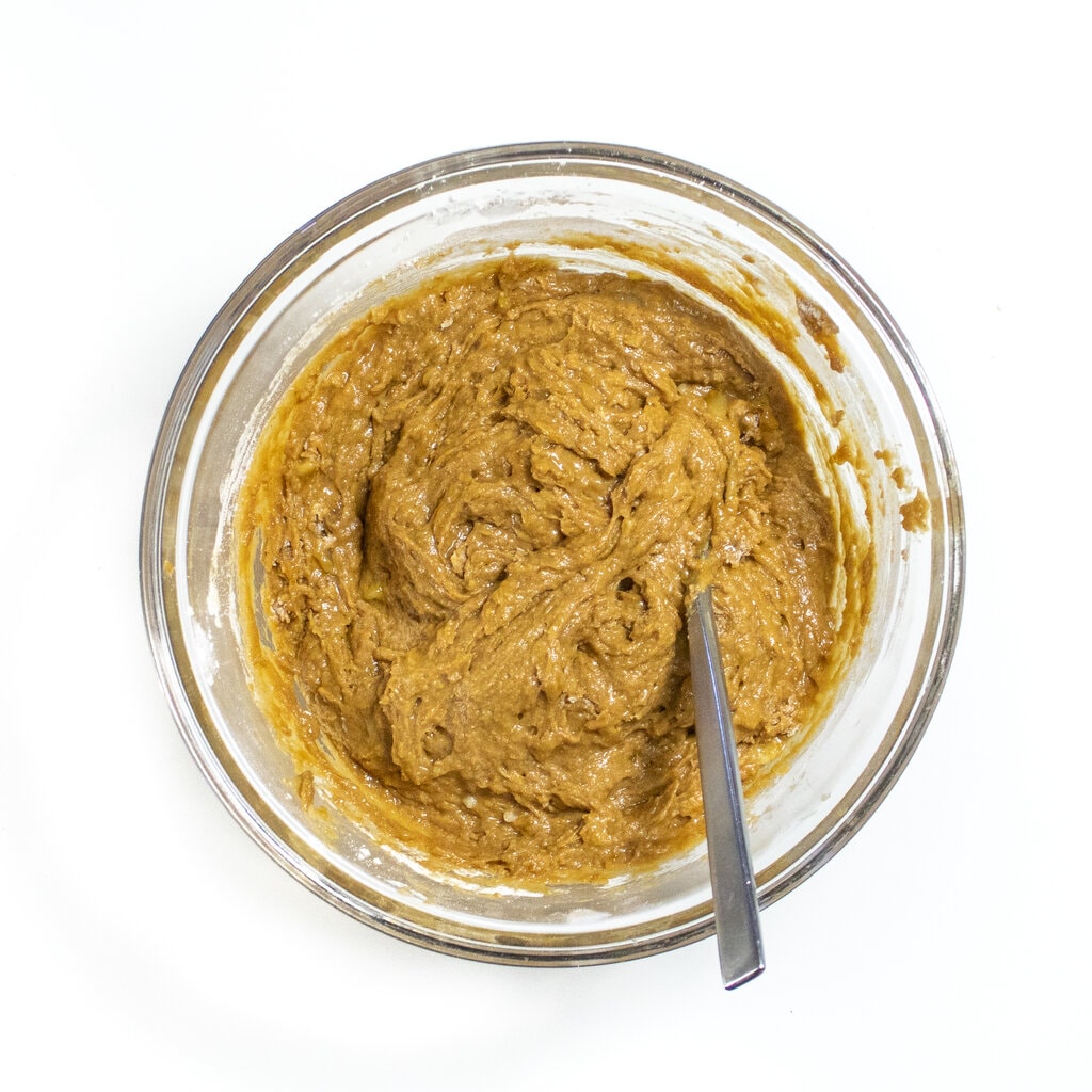 Clear mixing bowl with batter for healthy gingerbread muffins.