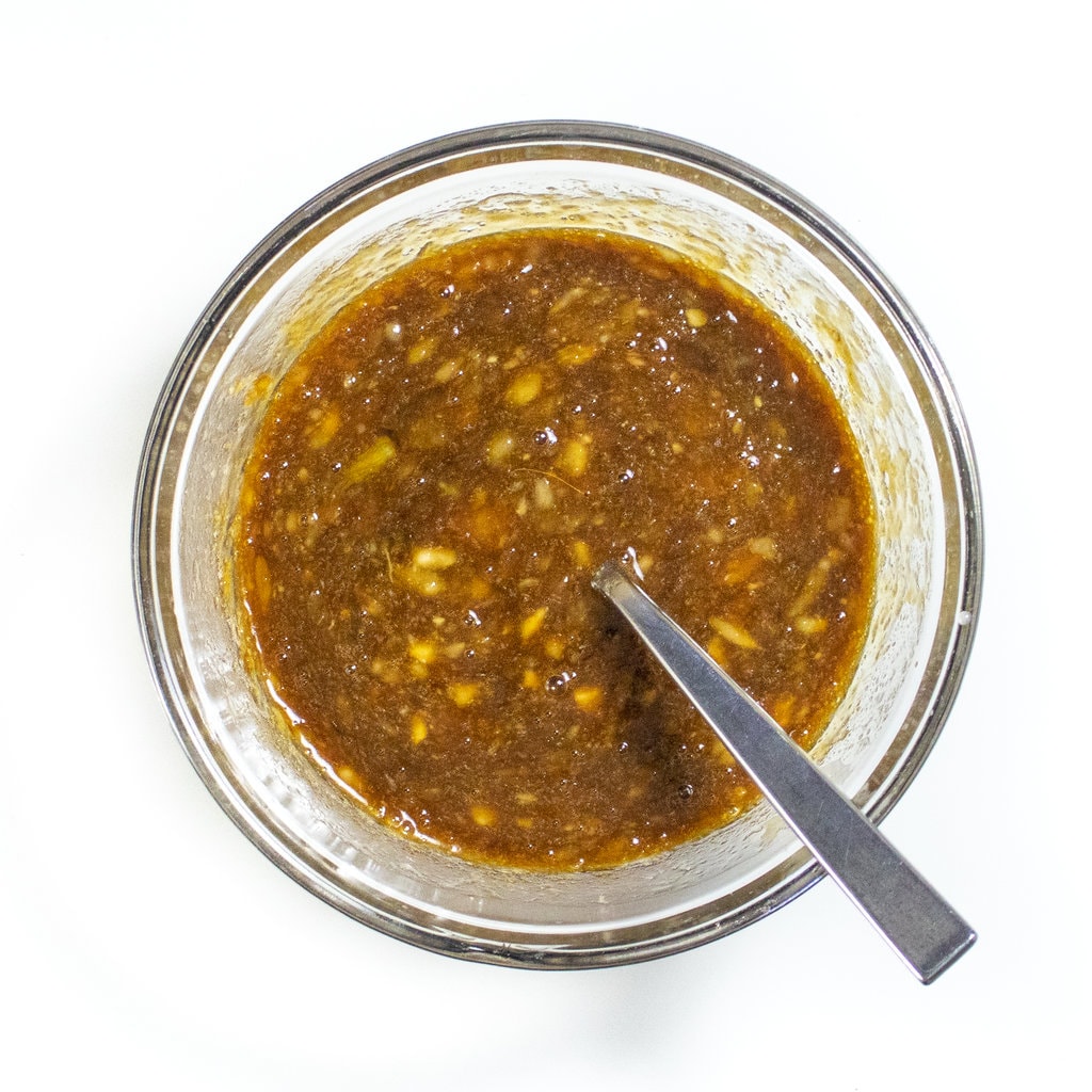 Clear mixing bowl with mixed wet ingredients.