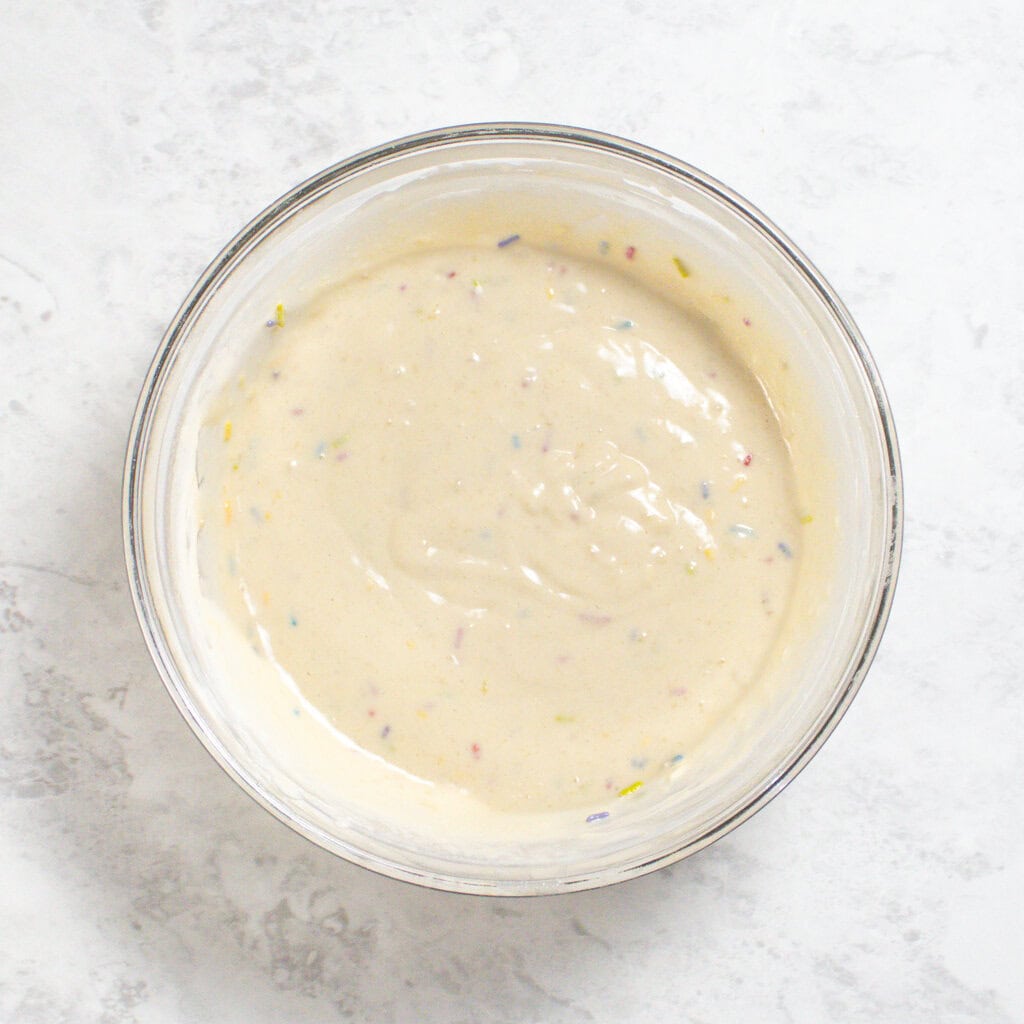 Glass bowl on my white kitchen counter with funfetti pancake batter.