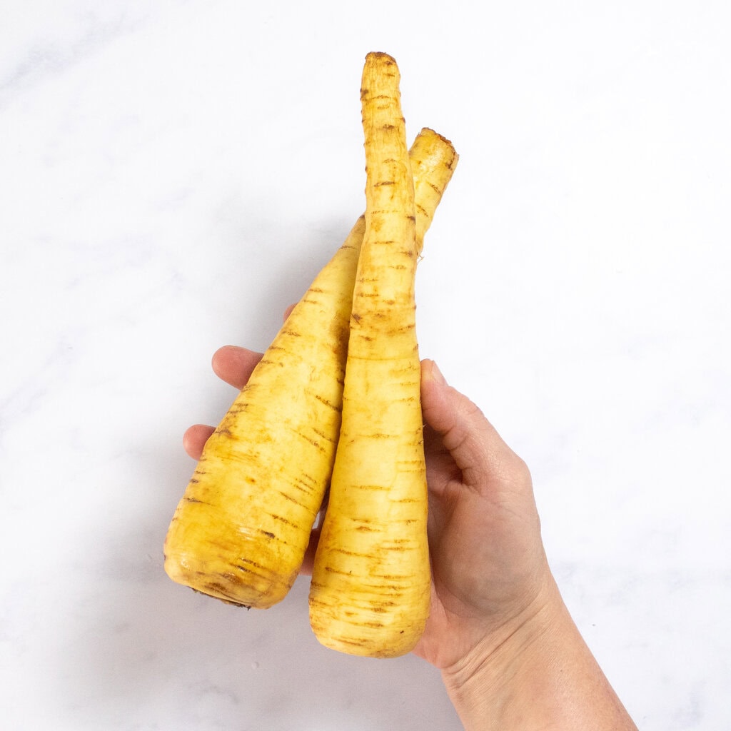 My hangs holding two parsnips over my kitchen counter.