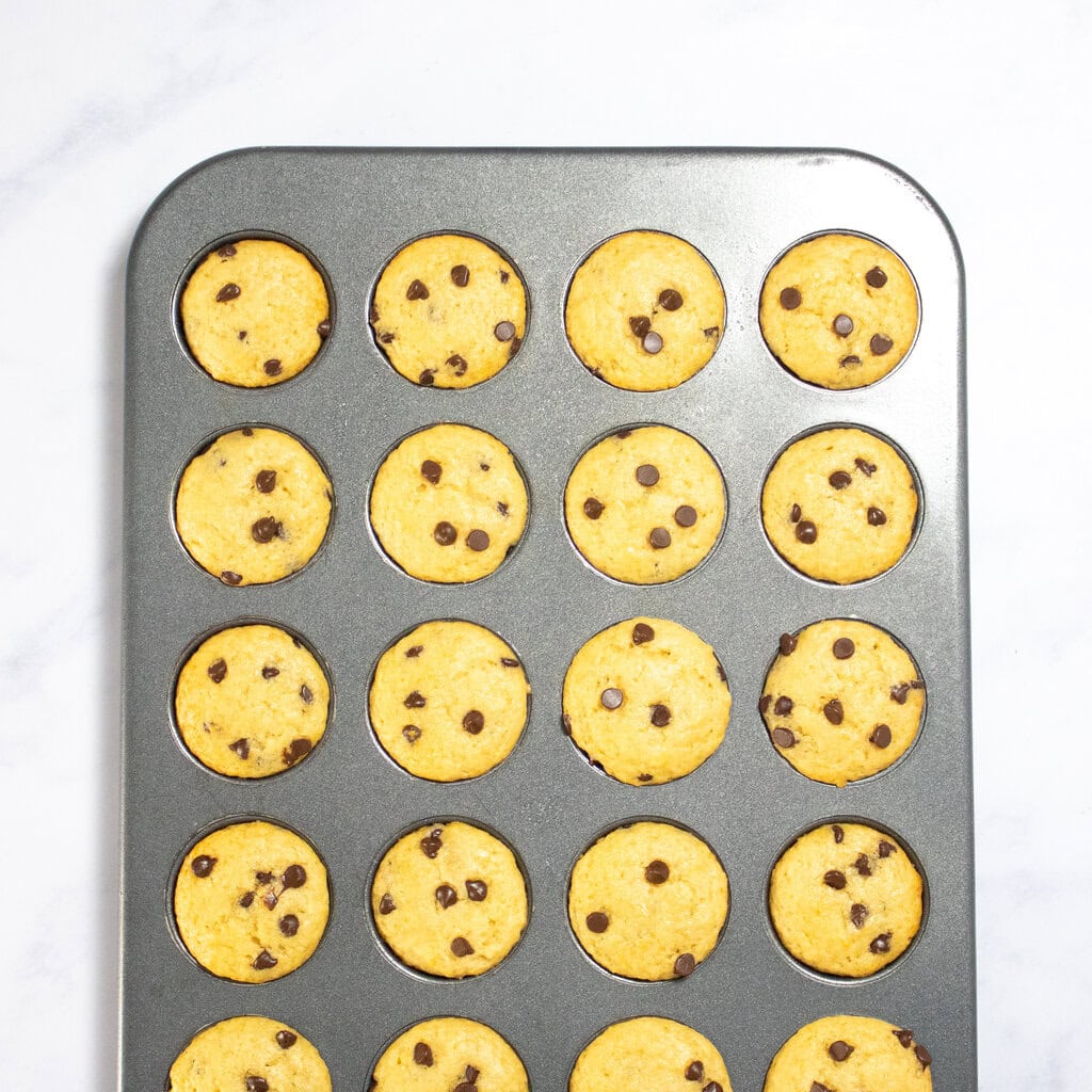Golden brown mini chocolate chip muffins inside.